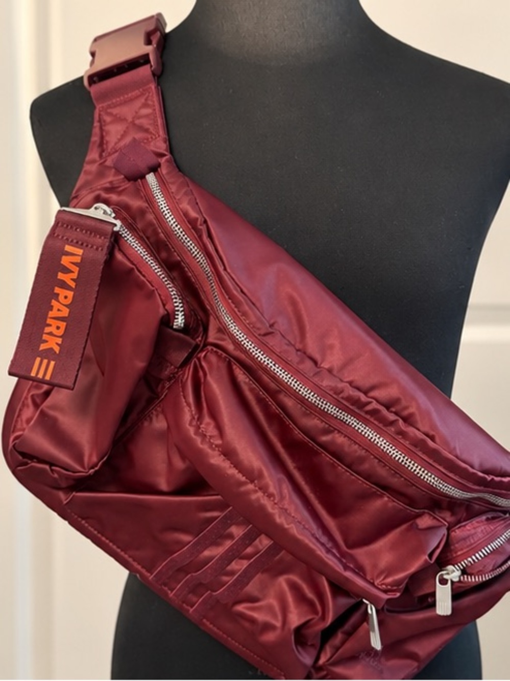 IVY PARK Burgundy Sling Belt Bag with Orange Logo Tab